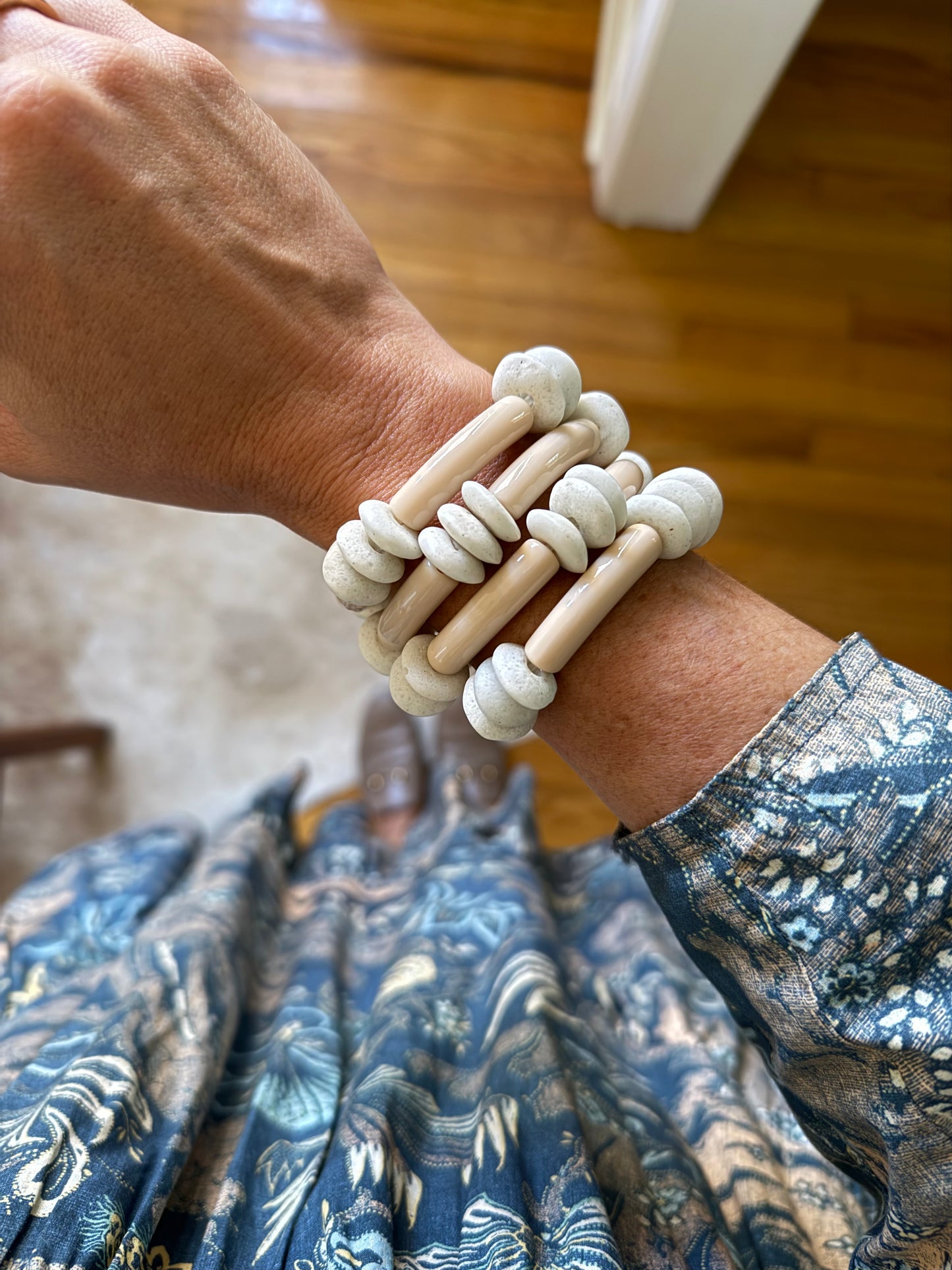 Cream acrylic bracelet stack featuring smooth, lightweight bands, perfect for layering and adding a chic touch to any outfit.