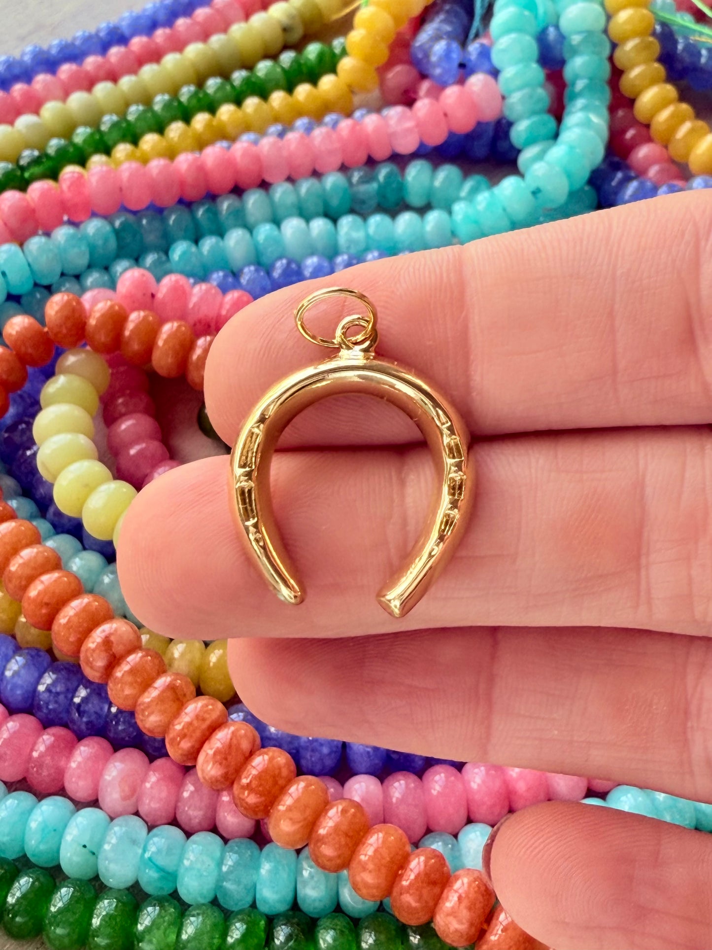 "Classic gold horseshoe charm ideal for any necklace, symbolizing good luck and adding a stylish touch to your necklaces.