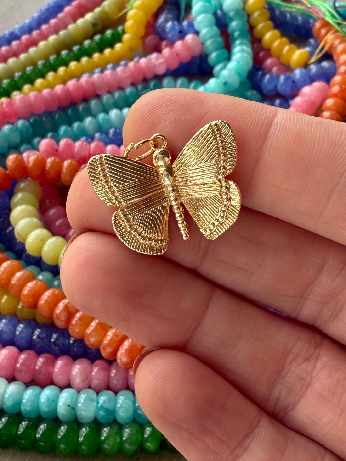 Delicate butterfly charm with intricate detailing.