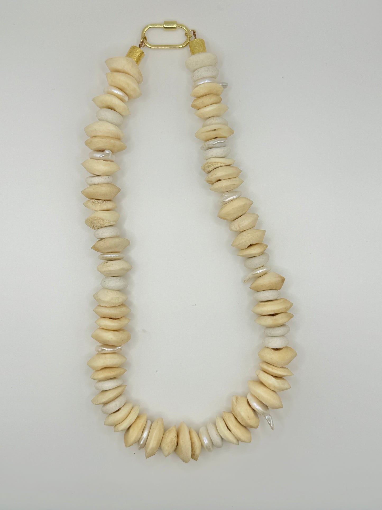 Unique cream wooden chunky necklace showcasing a mix of light and dark wood tones for a warm, earthy vibe.