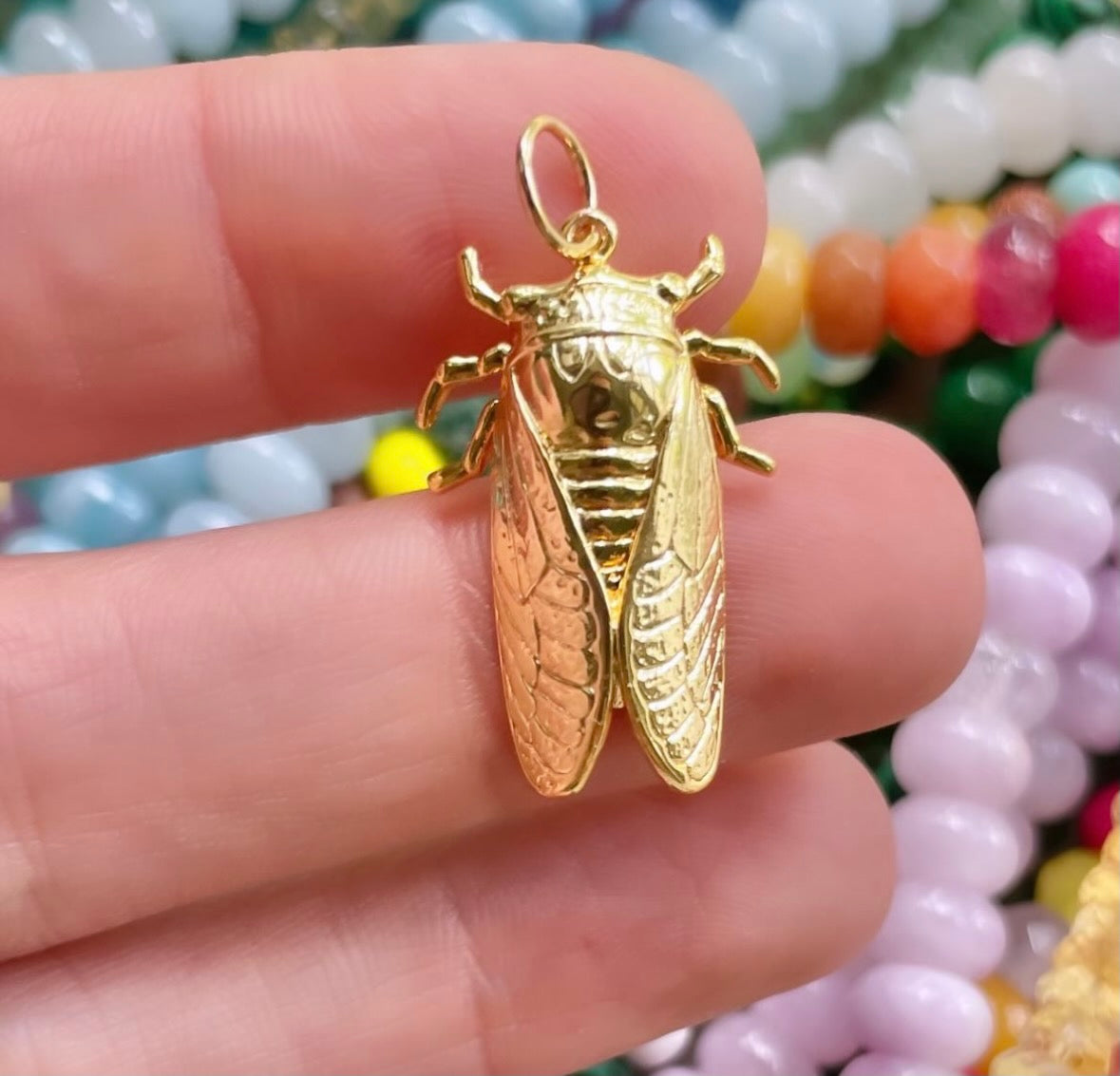 Delicate bug charm with intricate detailing.