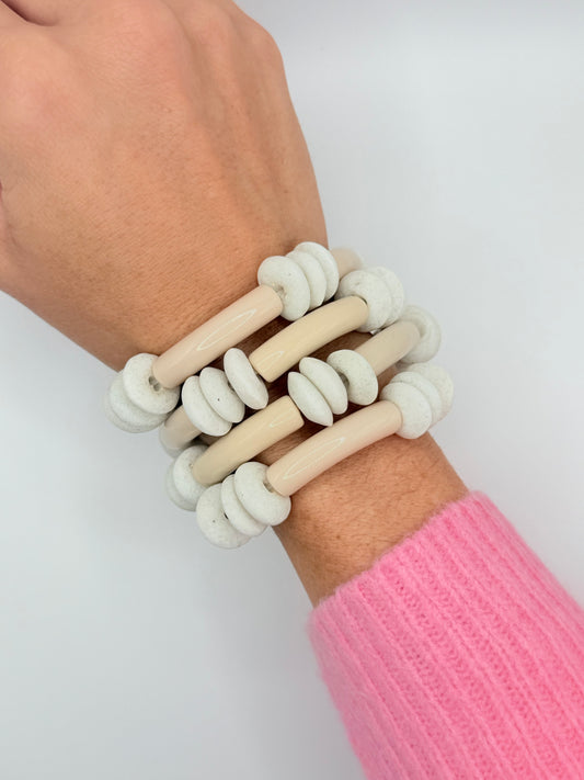 Stylish cream acrylic bracelet stack with a modern design, ideal for creating a minimalist and sophisticated look.