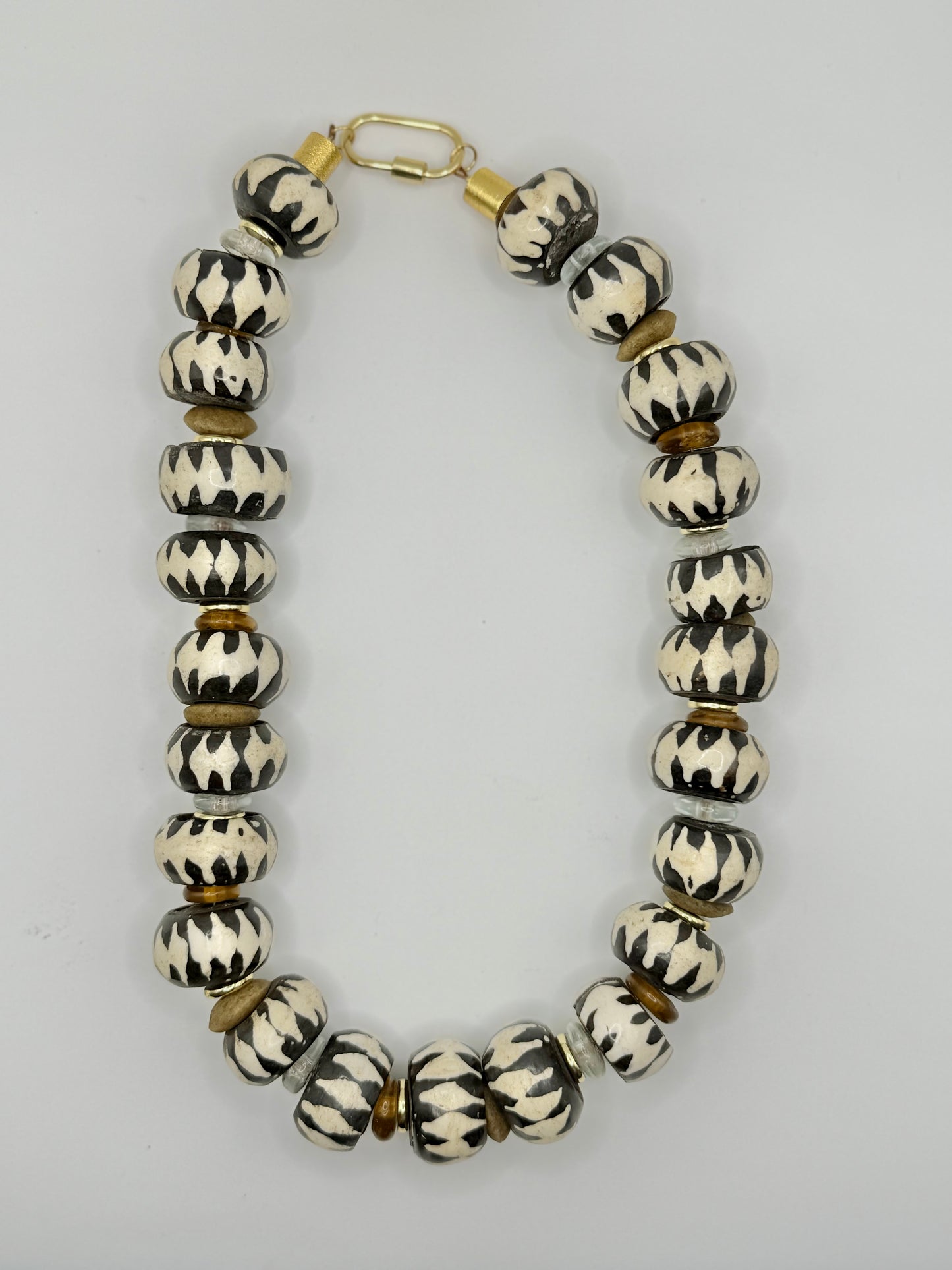 Bold cream and brown wooden chunky necklace with a rustic design, ideal for creating a statement look.