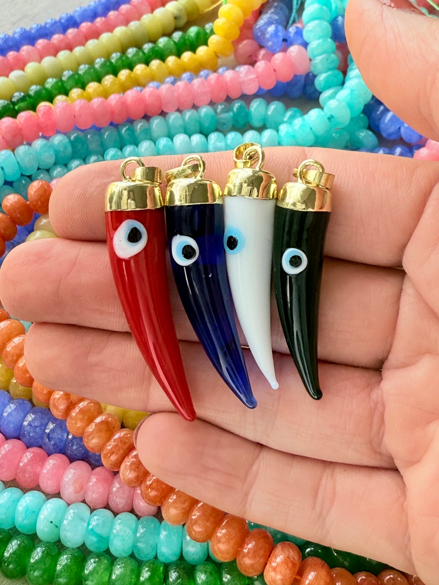 Vibrant evil eye pepper charm featuring a unique design, perfect for adding a touch of protection and cultural flair to your jewelry collection.