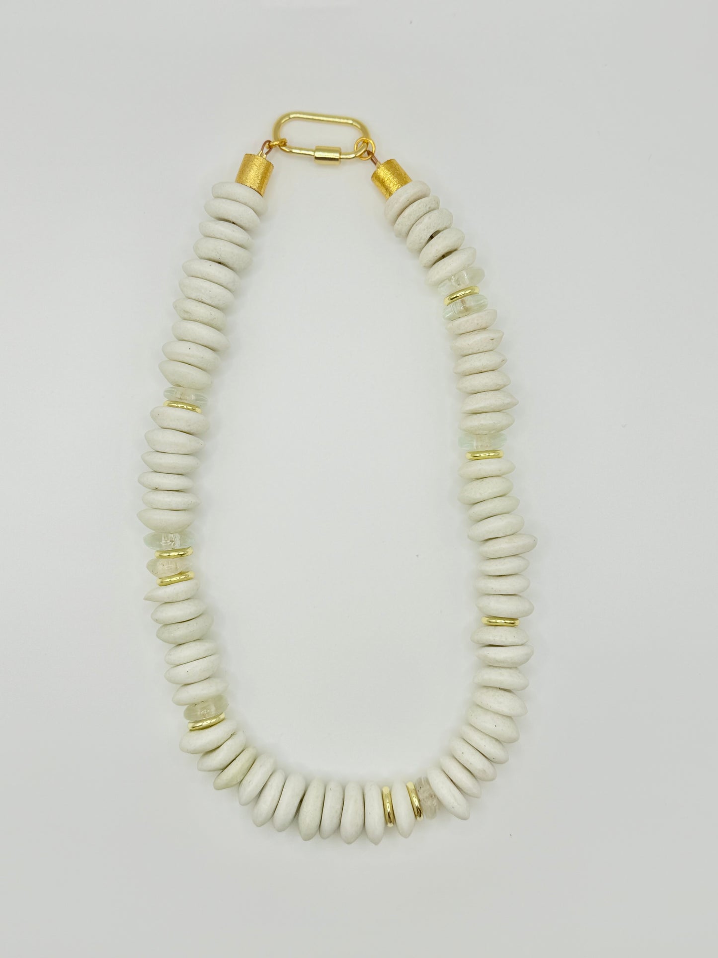 White beaded necklace featuring smooth, polished beads, perfect for a timeless and versatile look.