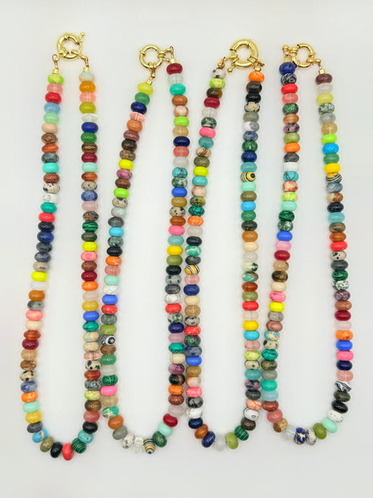 Collection of colorblock beaded necklaces featuring vibrant, contrasting colors, perfect for adding a playful and stylish touch to any outfit.