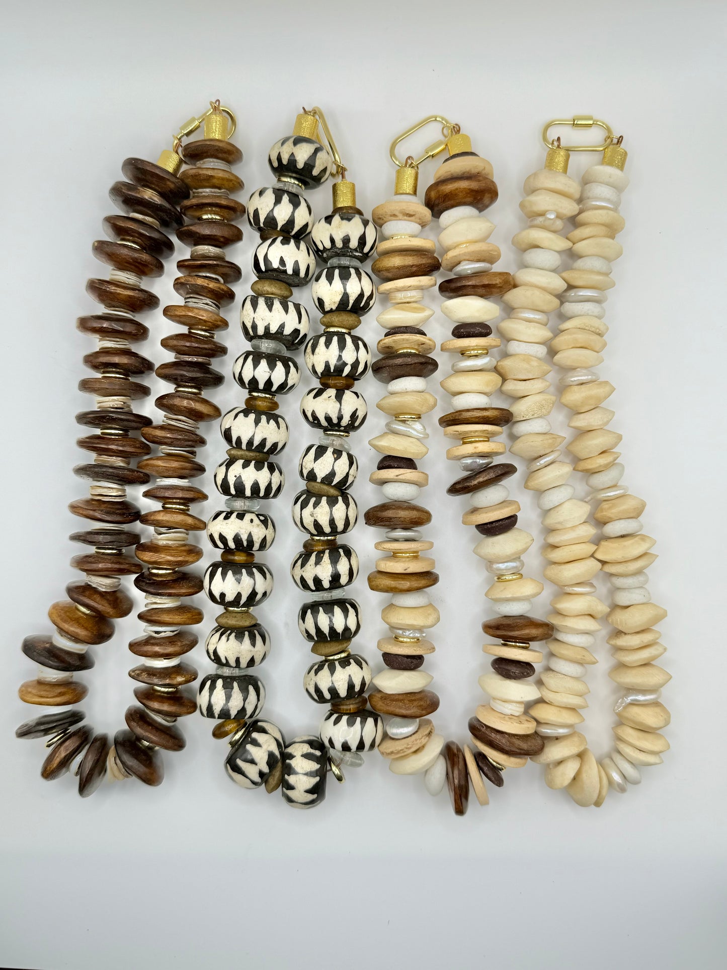 Stylish cream and brown wooden chunky necklace featuring oversized beads, perfect for adding natural elegance to any outfit.