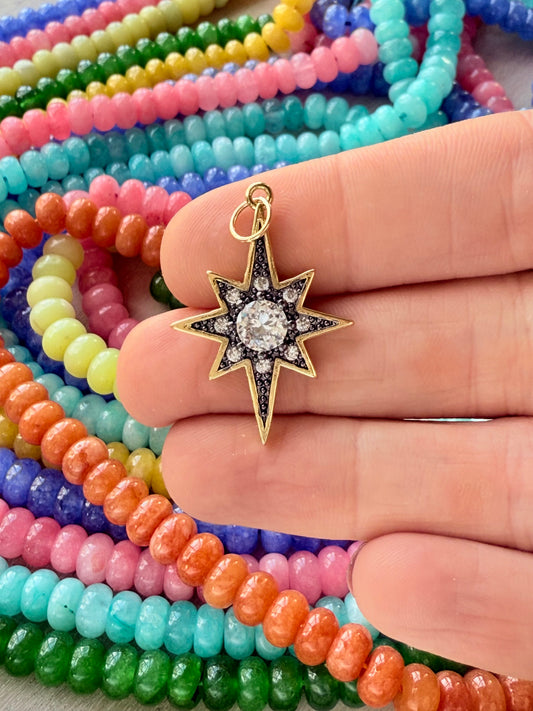 Sparkling starburst charm with dynamic design, perfect for adding a touch of glamour and whimsy to any jewelry collection.