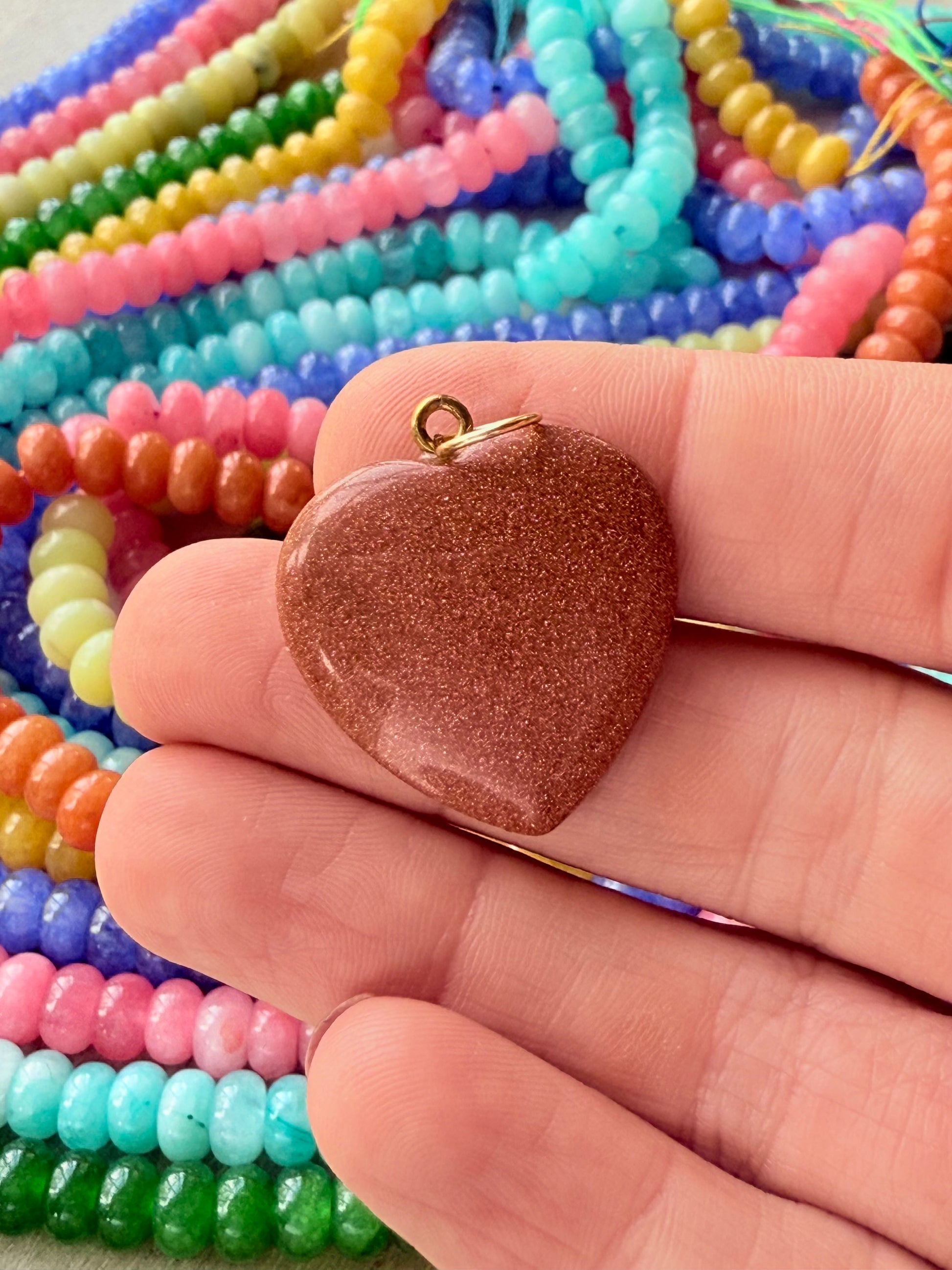 Vibrant puffy heart charms in various bright colors, perfect for adding a playful touch to any stack or necklace. 