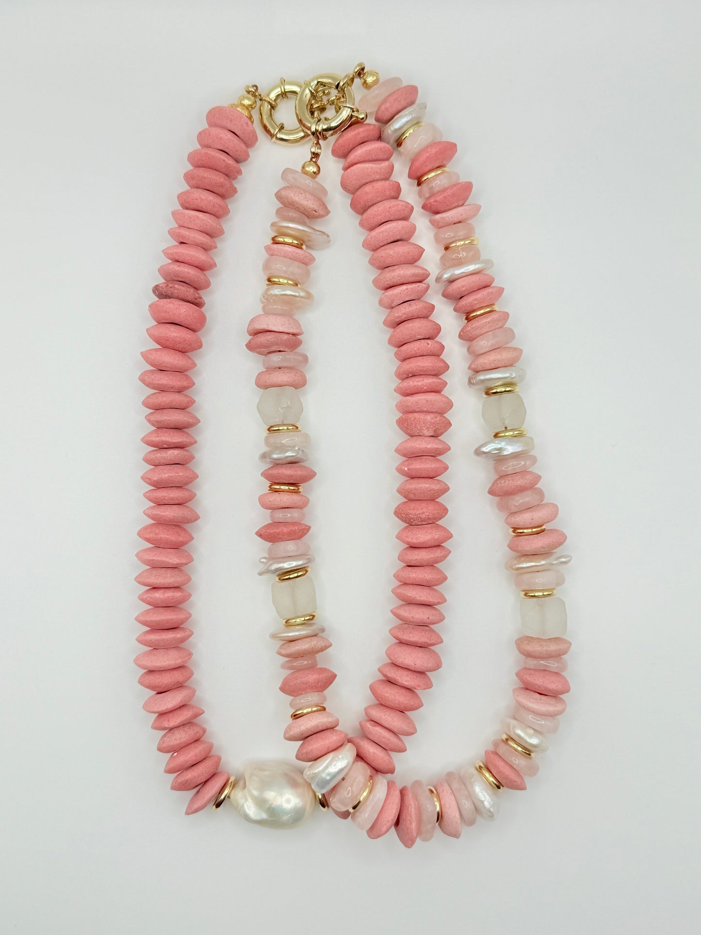 Bold chunky peach beaded necklaces with oversized beads and saltwater pearls, perfect for making a vibrant fashion statement and adding a pop of color.