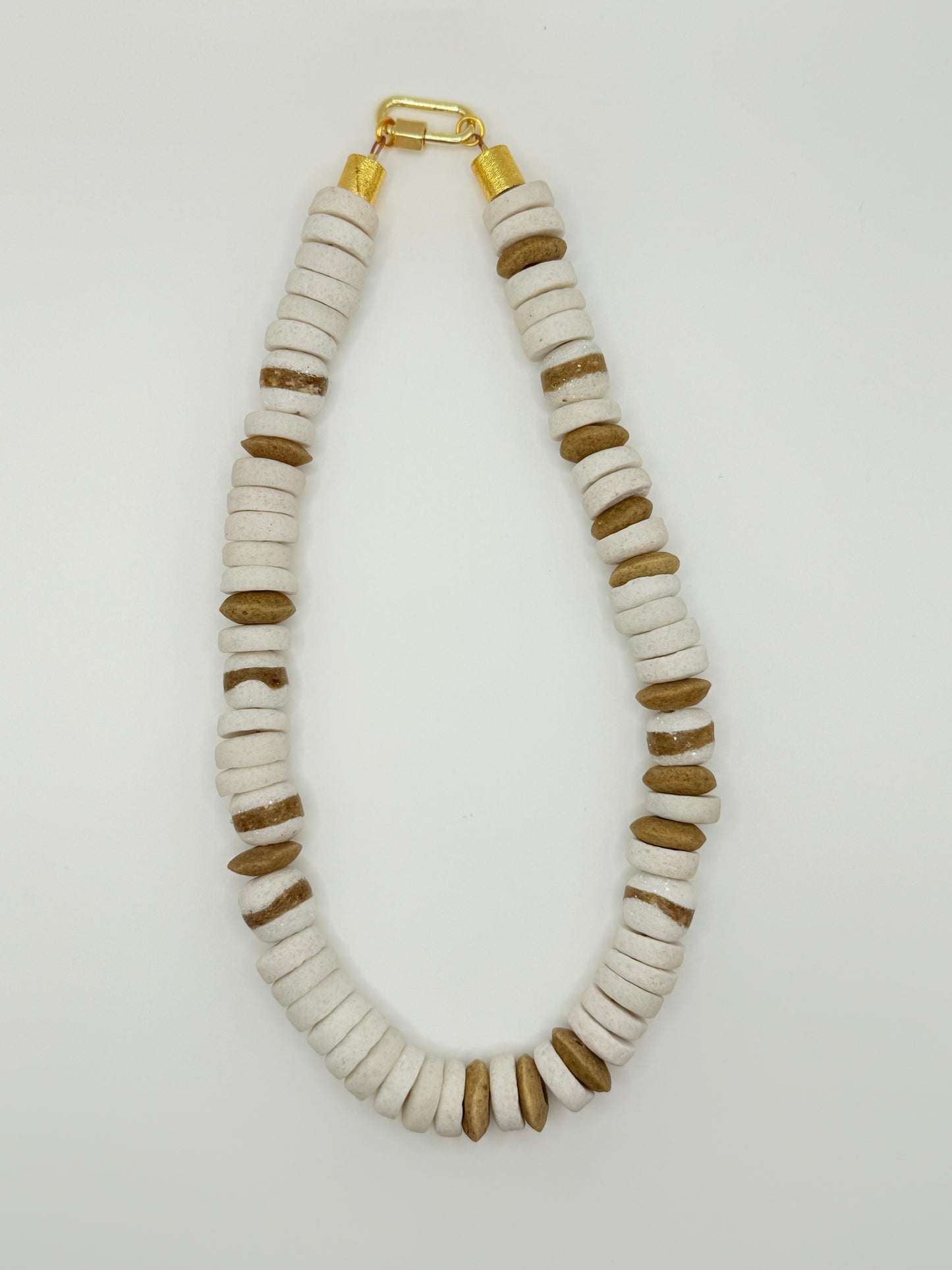 Stylish white and brown beaded necklace with a minimalist aesthetic, perfect for layering or wearing solo for a clean, modern look.